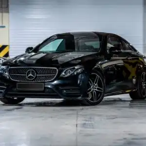 black Mercedes Benz E Class in a parking garage