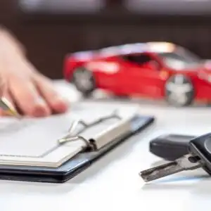 person signing a car contract