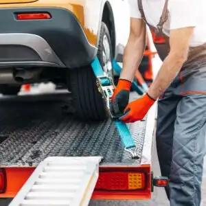 tow service personnel attaching tow straps to a car