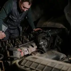 man rebuiling an engine
