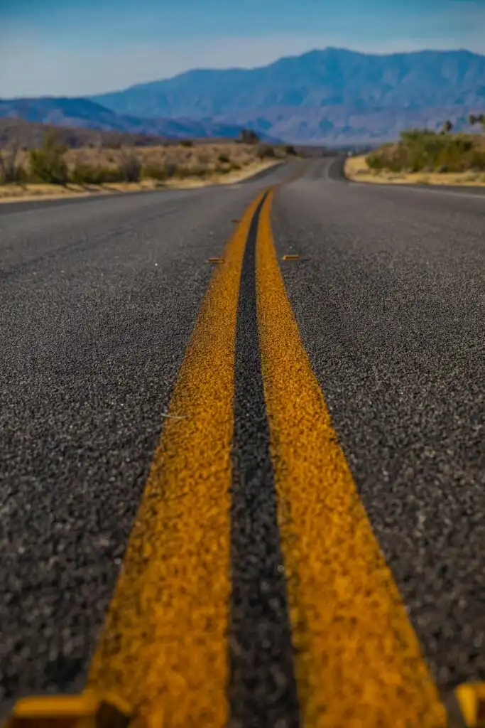 a solid yellow-line road