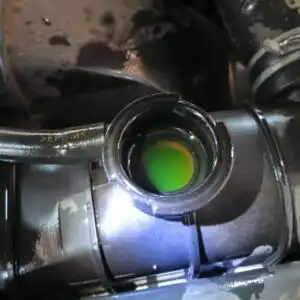 open radiator filler neck with green antifreeze