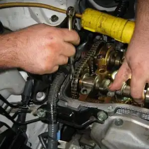 mechanic accessing overhead camshaft